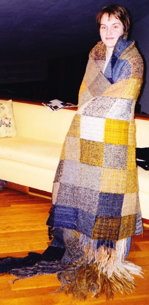 Heather MacKenzie, photographed in January 2000, wrapped in a double-cloth block blanket, hot off the loom